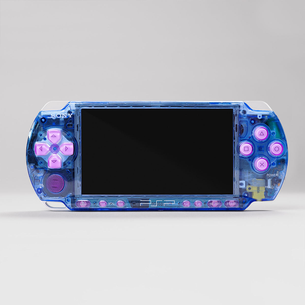 Front view of a custom Sony PSP with a blue transparent shell and pastel pink buttons, showcasing a vibrant and modded handheld console
