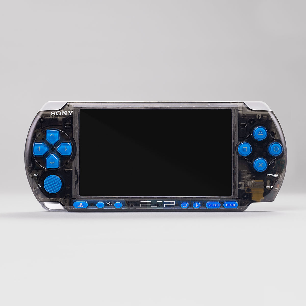 A transparent black PlayStation Portable with bright blue OEM buttons and polished detailing, showcasing a custom PlayingScorp rebuild that preserves the original PSP feel in a modern, clear-shell design.